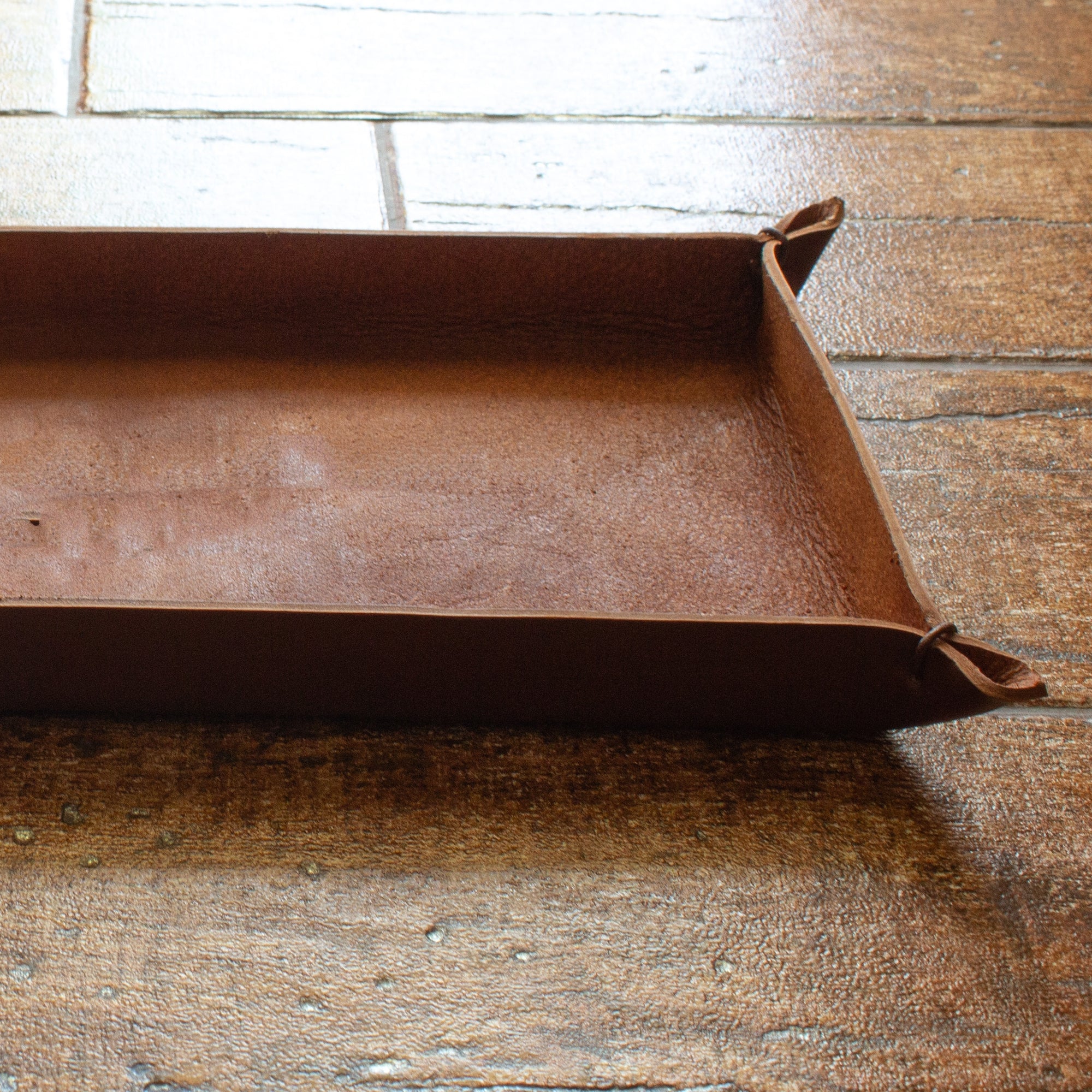 A view of a rectangular whisky brown-colored tray made from Italian full-grain leather.