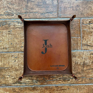 Brown whiskey leather tray with name and initials engraving on a wooden surface