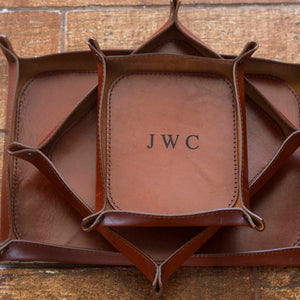 Set of three, small, medium, and large, engraved Italian leather valet trays in brown whiskey color.