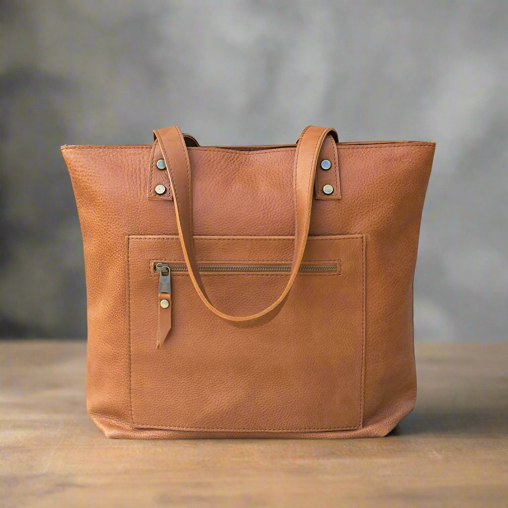 Large tote bag in mattone-colored Italian leather, handcrafted with a front double-zip pocket for added convenience. A unique, timeless gift for yourself or a loved one.