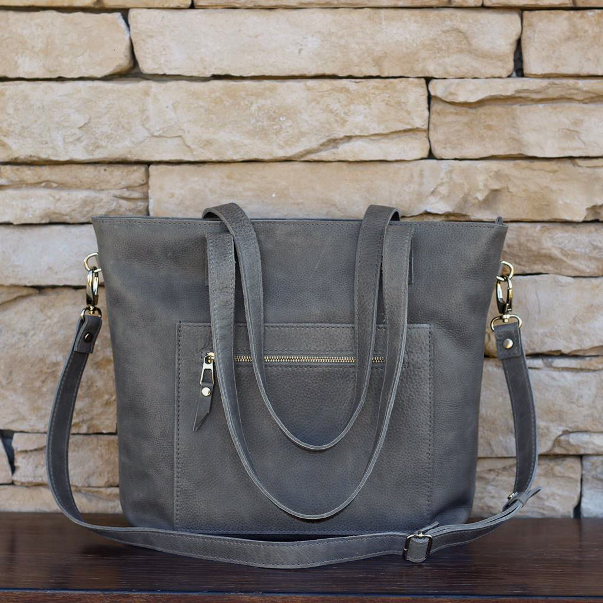 Large tote bag in antracite-colored Italian leather, handcrafted with a front double-zip pocket and a long detachable strap, for added convenience. A unique, timeless gift for yourself or a loved one.