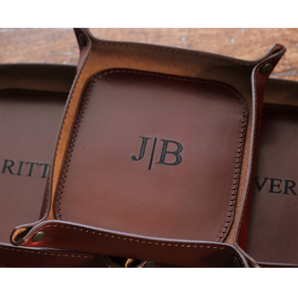 Set of three medium, engraved Italian leather valet trays in brown whiskey color.