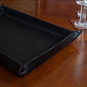 View of a black-colored, large size Italian leather tray with leather cords at each corner