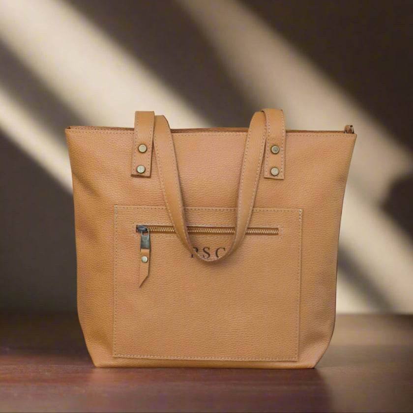 Tote bag made of high-quality Italian leather with a zip pocket and an optional top zip closure.