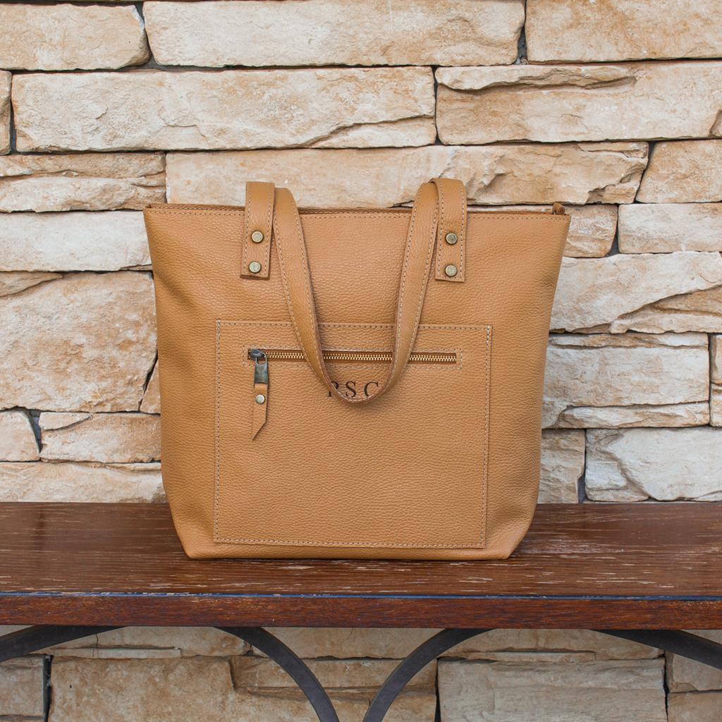 Tote bag made of high-quality Italian leather with a zip pocket and an optional top zip closure.